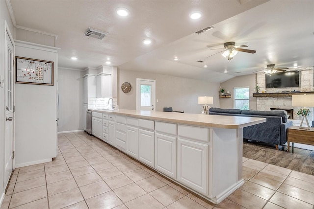 136 NW Suzanne Ter, Burleson, TX 76028 - kitchen featuring a ceiling fan, a peninsula, light tile patterned floors, light countertops, and white cabinets