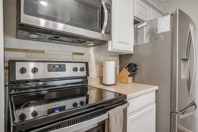 136 NW Suzanne Ter, Burleson, TX 76028 - kitchen featuring appliances with stainless steel finishes, tasteful backsplash, white cabinetry, and light countertops