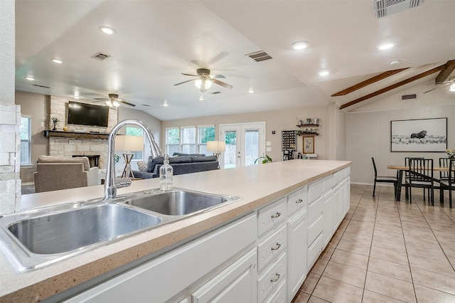 136 NW Suzanne Ter, Burleson, TX 76028 - kitchen with ceiling fan, a sink, vaulted ceiling, a stone fireplace, and open floor plan