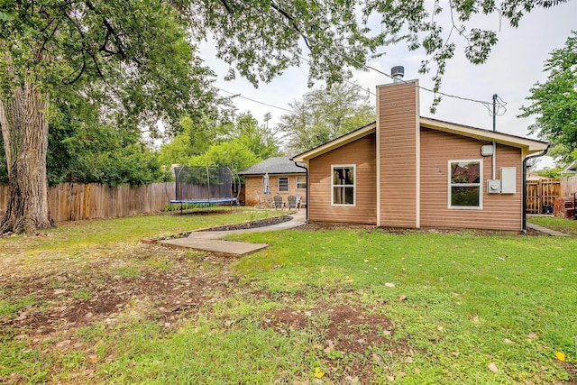 136 NW Suzanne Ter, Burleson, TX 76028 - rear view of property featuring a trampoline and a chimney