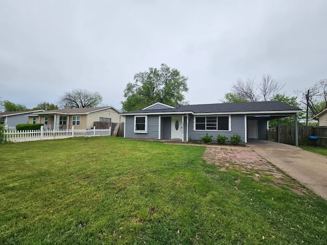 ranch-style home with concrete driveway, a carport, fence, and a front lawn