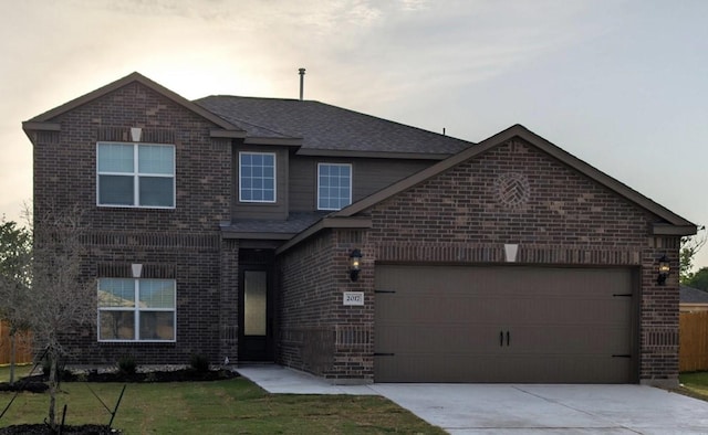 traditional-style house featuring driveway, an attached garage, a front lawn, brick siding, and a shingled roof