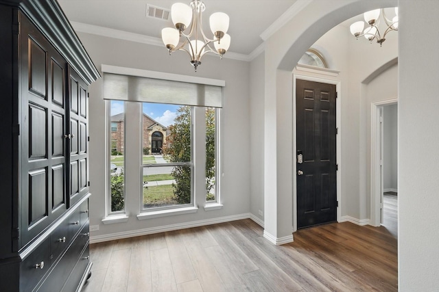 1125 Overton St, Frisco, TX 75036 - entryway with a chandelier, arched walkways, light wood-style flooring, baseboards, and crown molding