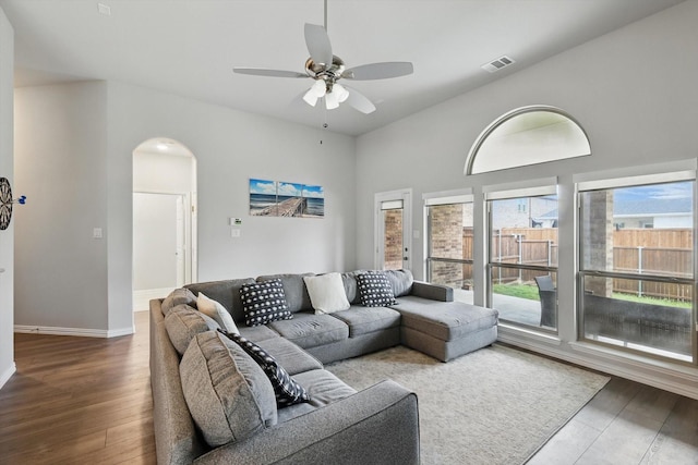1125 Overton St, Frisco, TX 75036 - living room featuring wood finished floors, ceiling fan, arched walkways, and baseboards