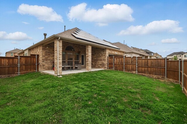 1125 Overton St, Frisco, TX 75036 - back of house featuring roof mounted solar panels, a patio, and brick siding