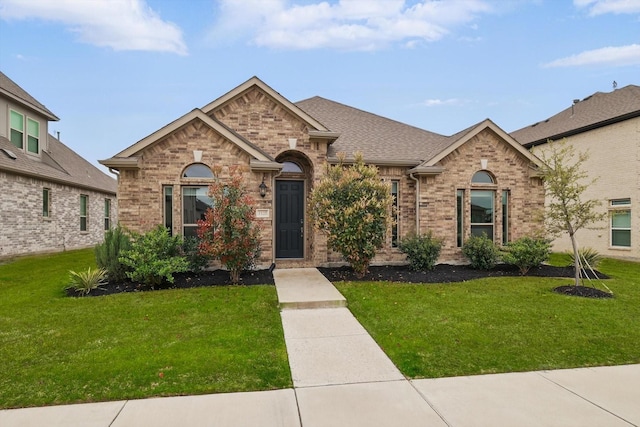 1125 Overton St, Frisco, TX 75036 - french country style house featuring a front yard and brick siding
