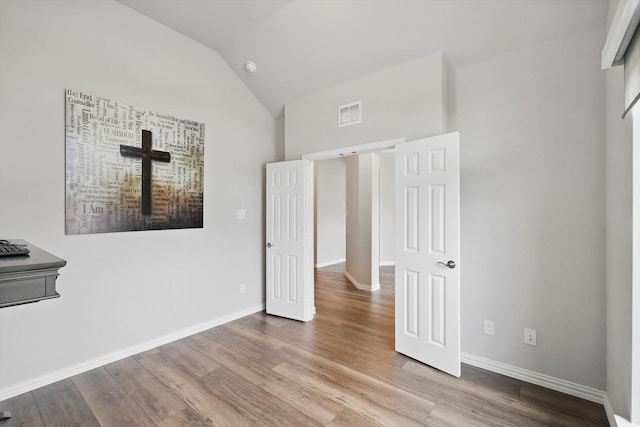 1125 Overton St, Frisco, TX 75036 - unfurnished bedroom with wood finished floors, baseboards, and high vaulted ceiling