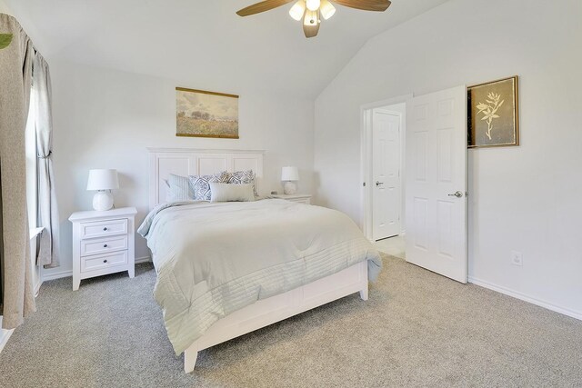 bedroom featuring light carpet, lofted ceiling, a ceiling fan, and baseboards