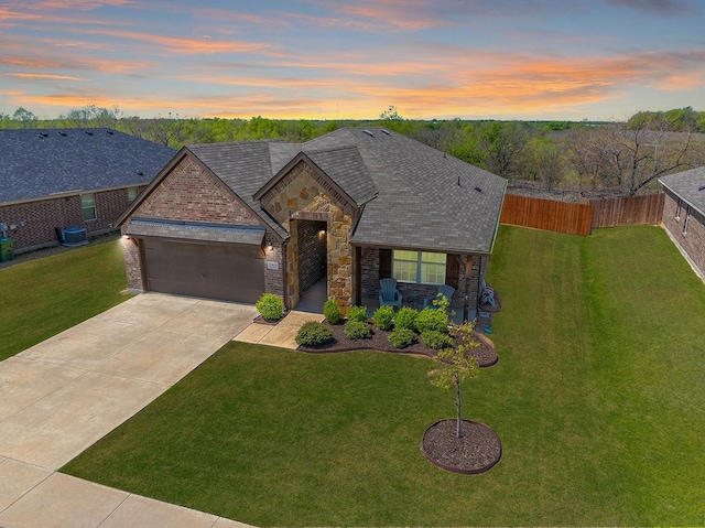 view of front facade featuring stone siding, a garage, concrete driveway, roof with shingles, and brick siding