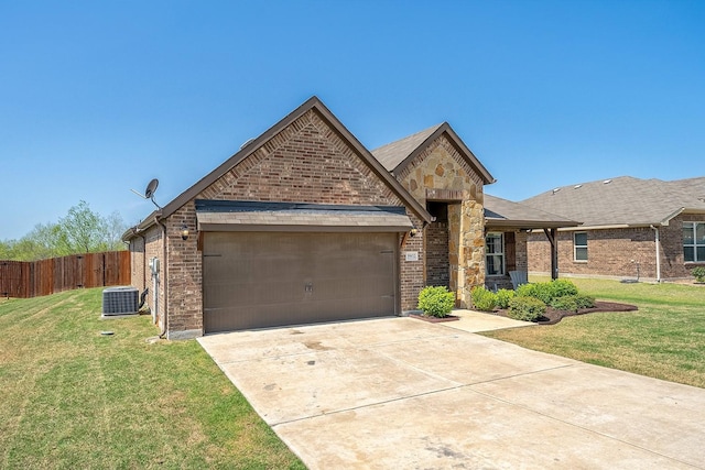 french country inspired facade with cooling unit, brick siding, an attached garage, and concrete driveway