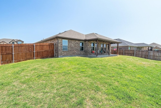 back of property with brick siding and a patio