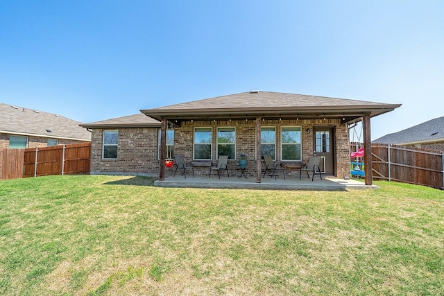 rear view of house featuring brick siding and a patio