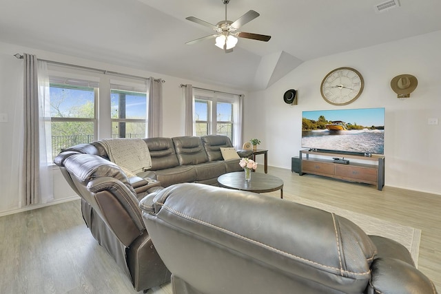 living room featuring a ceiling fan, vaulted ceiling, wood finished floors, and baseboards