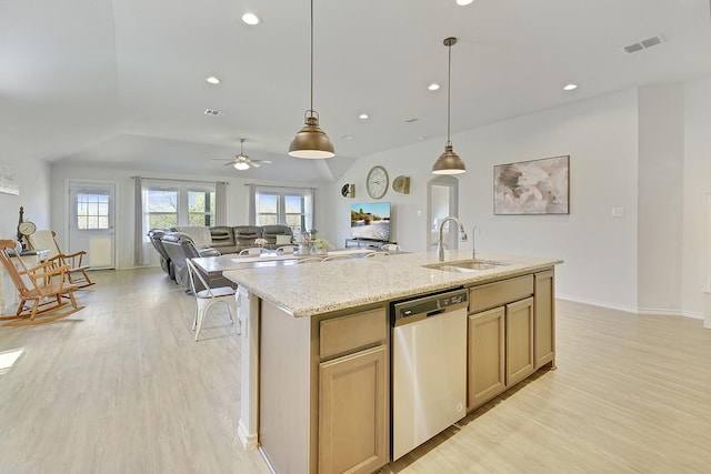 kitchen featuring dishwasher, a sink, vaulted ceiling, light wood-type flooring, and ceiling fan
