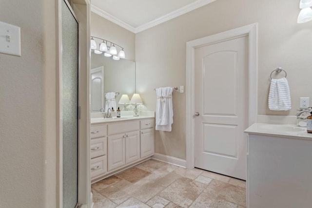 bathroom with vanity, stone tile flooring, crown molding, baseboards, and a stall shower