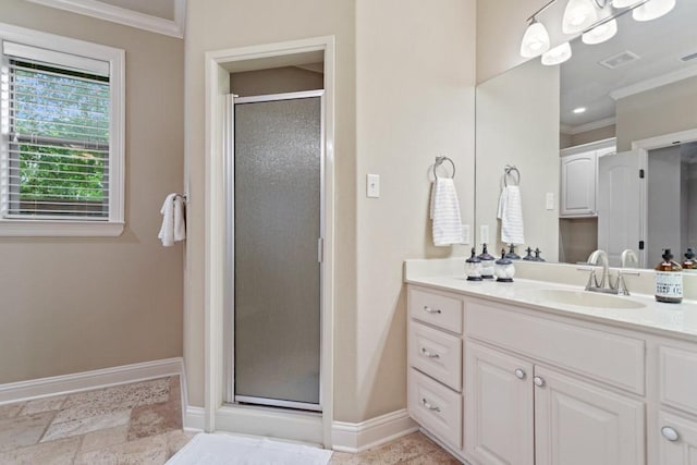 full bathroom with a shower stall, baseboards, crown molding, and vanity