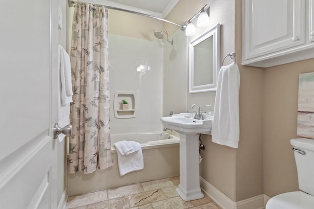 full bath featuring shower / tub combo, toilet, a sink, and baseboards