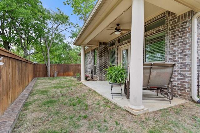 view of yard featuring a ceiling fan, a patio, and a fenced backyard