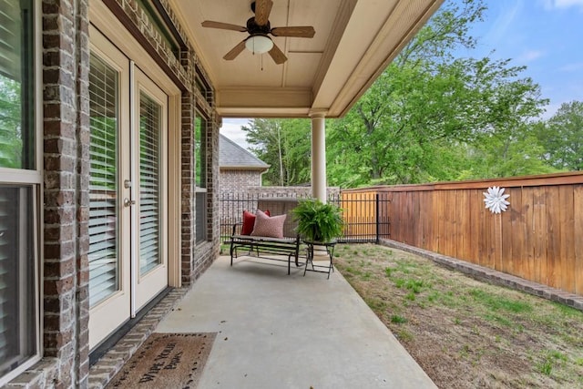 view of patio / terrace featuring a fenced backyard, ceiling fan, and french doors