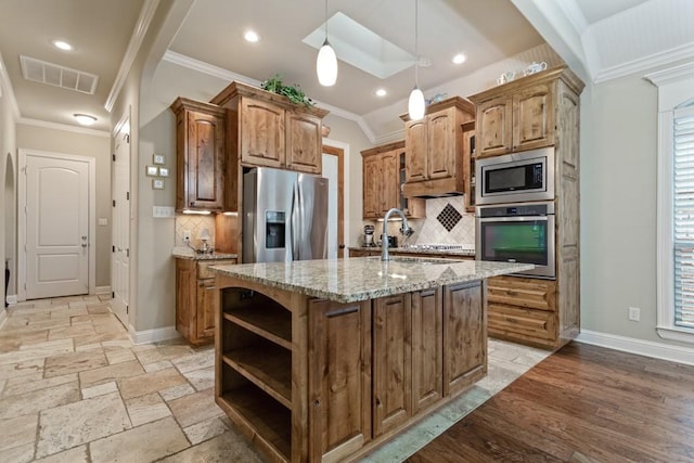 kitchen with stainless steel appliances, a sink, visible vents, light stone countertops, and ornamental molding