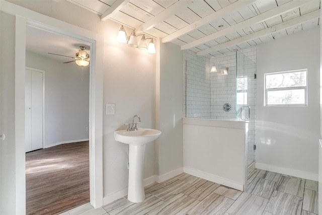 bathroom with lofted ceiling with beams, baseboards, ceiling fan, a walk in shower, and wood ceiling