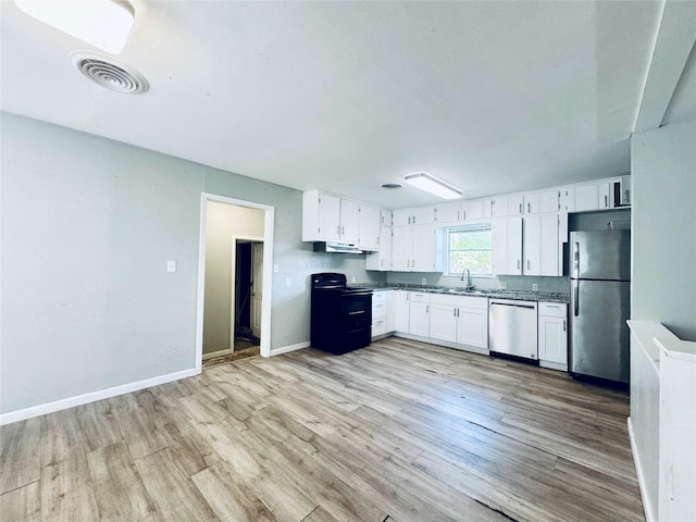 kitchen with light wood-style flooring, appliances with stainless steel finishes, a sink, and visible vents