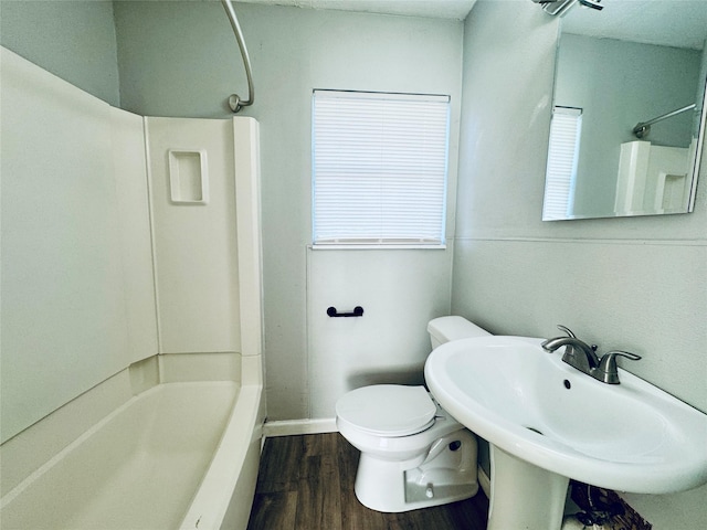 full bathroom with toilet, wood finished floors, baseboards, and bathtub / shower combination