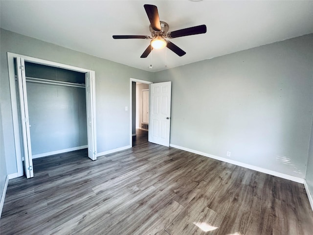 unfurnished bedroom featuring a closet, baseboards, ceiling fan, and wood finished floors