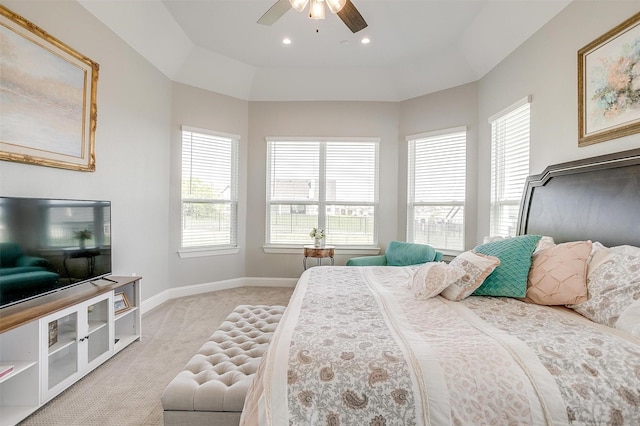 bedroom with baseboards, multiple windows, ceiling fan, and light colored carpet