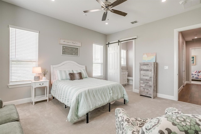bedroom with carpet flooring, visible vents, baseboards, and attic access