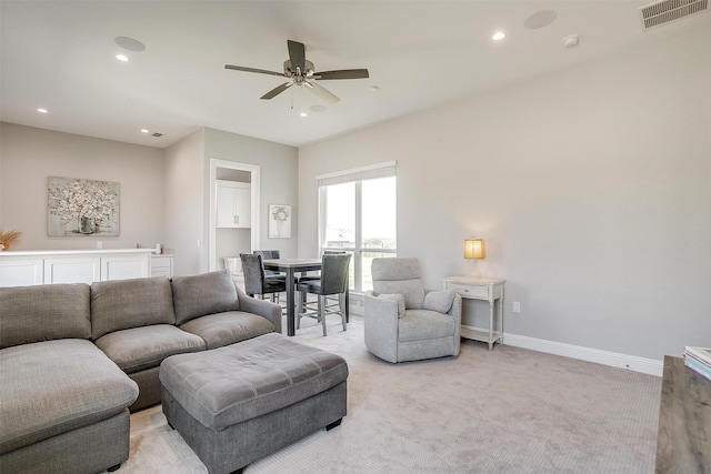 living area with baseboards, recessed lighting, visible vents, ceiling fan, and light colored carpet