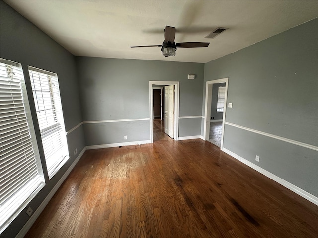 301 E White St, Pilot Point, TX 76258 - unfurnished bedroom featuring wood finished floors, baseboards, and ceiling fan