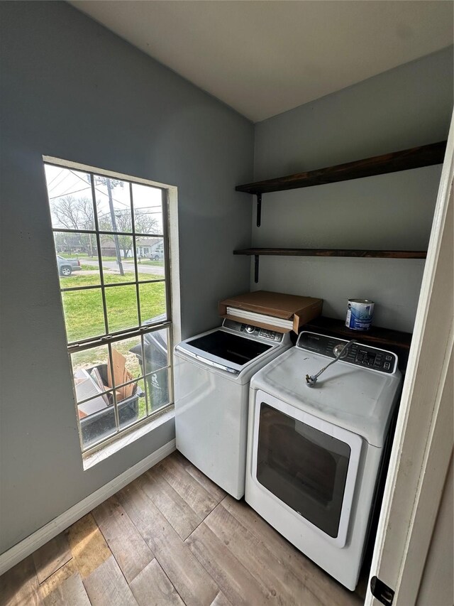 301 E White St, Pilot Point, TX 76258 - washroom featuring washing machine and dryer, light wood finished floors, and baseboards