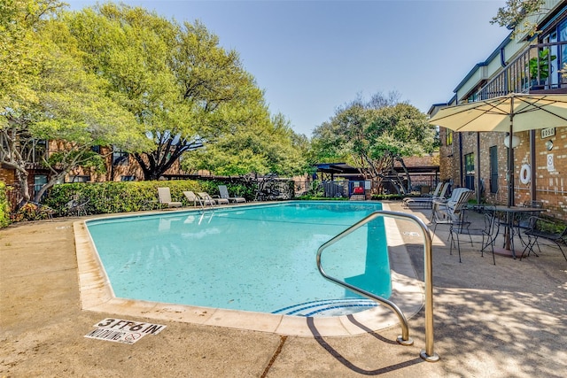 6050 Birchbrook Dr Unit 142, Dallas, TX 75206 - community pool with a patio area