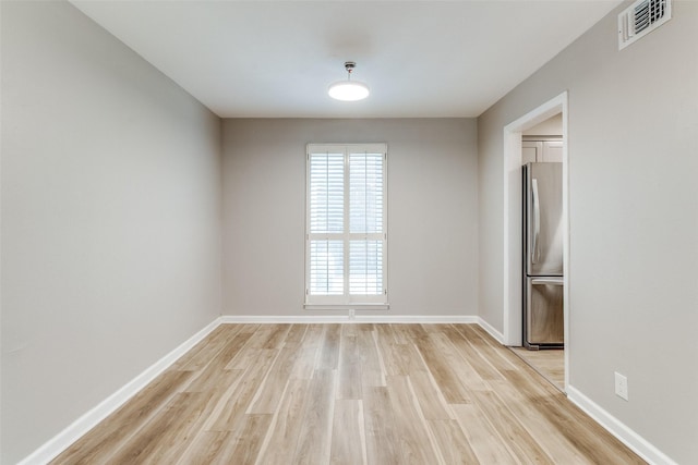 6050 Birchbrook Dr Unit 142, Dallas, TX 75206 - spare room with light wood-style flooring and baseboards