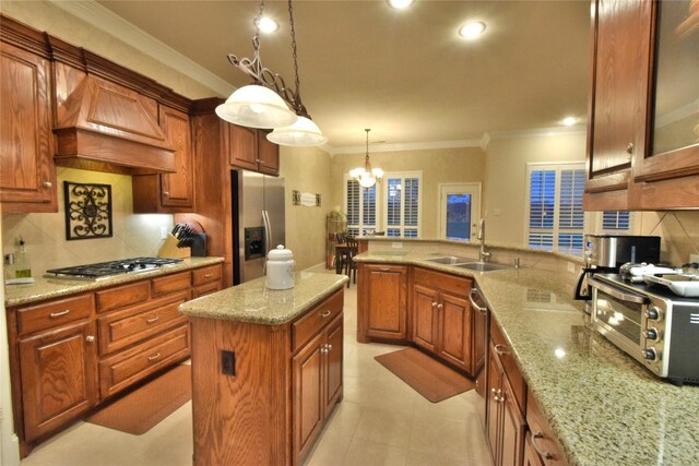 13111 Saint Orlin Way, Talty, TX 75126 - kitchen featuring appliances with stainless steel finishes, a sink, decorative backsplash, crown molding, and light stone countertops