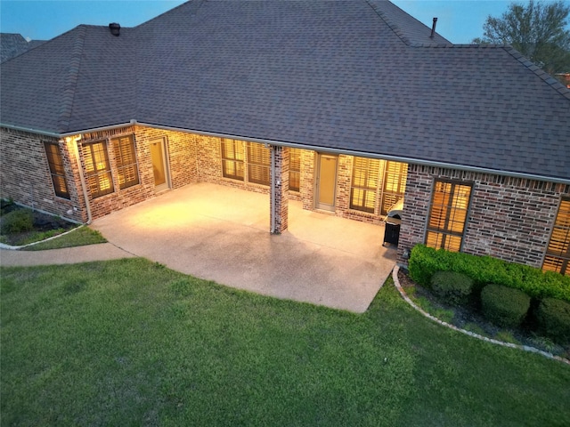 13111 Saint Orlin Way, Talty, TX 75126 - rear view of house with a patio area, roof with shingles, a yard, and brick siding