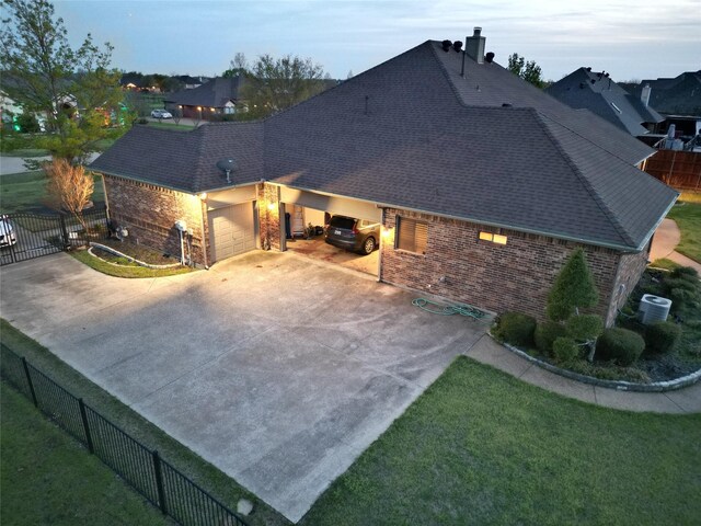 13111 Saint Orlin Way, Talty, TX 75126 - rear view of house with brick siding, roof with shingles, a chimney, concrete driveway, and an attached garage