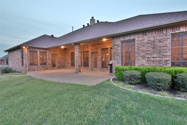 13111 Saint Orlin Way, Talty, TX 75126 - back of house featuring brick siding, a yard, and a patio