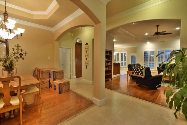 13111 Saint Orlin Way, Talty, TX 75126 - dining space with arched walkways, a ceiling fan, crown molding, a tray ceiling, and a chandelier