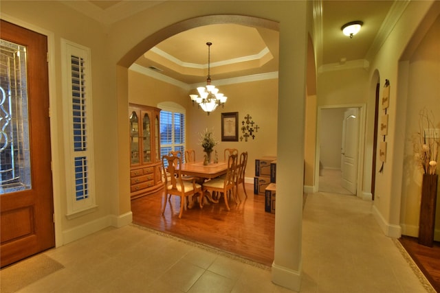 13111 Saint Orlin Way, Talty, TX 75126 - dining space with arched walkways, a raised ceiling, crown molding, baseboards, and a chandelier