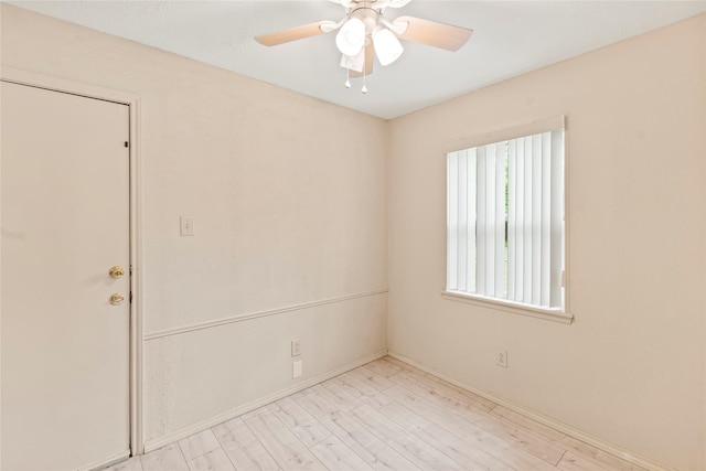 empty room with a ceiling fan and wood finished floors