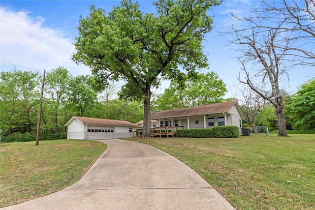 ranch-style home featuring an outdoor structure, covered porch, a garage, and a front lawn