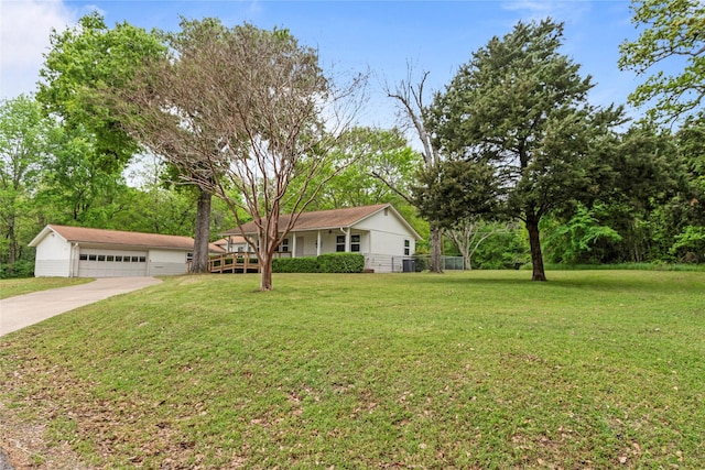 single story home featuring a front yard and a detached garage