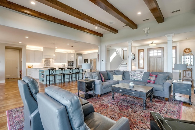 8225 Scotscraig Ct, Cleburne, TX 76033 - living area featuring ornate columns, light wood-style flooring, beam ceiling, stairs, and recessed lighting
