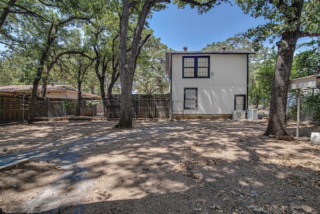rear view of house featuring fence
