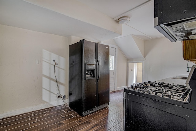 kitchen with lofted ceiling, range hood, baseboards, black appliances, and wood tiled floor