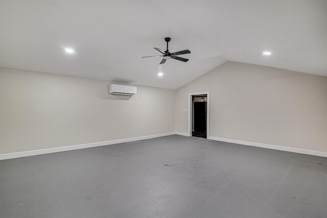 empty room with baseboards, a ceiling fan, concrete flooring, vaulted ceiling, and an AC wall unit