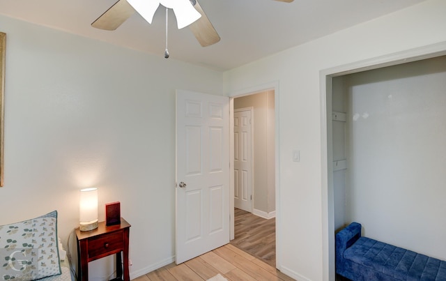 bedroom with baseboards, light wood-style floors, and a ceiling fan