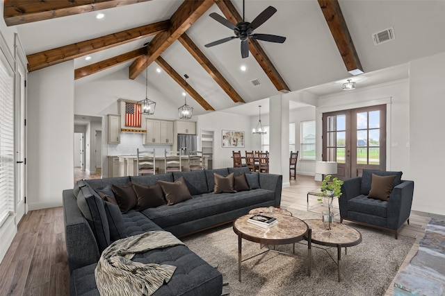 2017 Antler Loop, Poolville, TX 76487 - living area with light wood-style flooring, ceiling fan with notable chandelier, beam ceiling, and visible vents